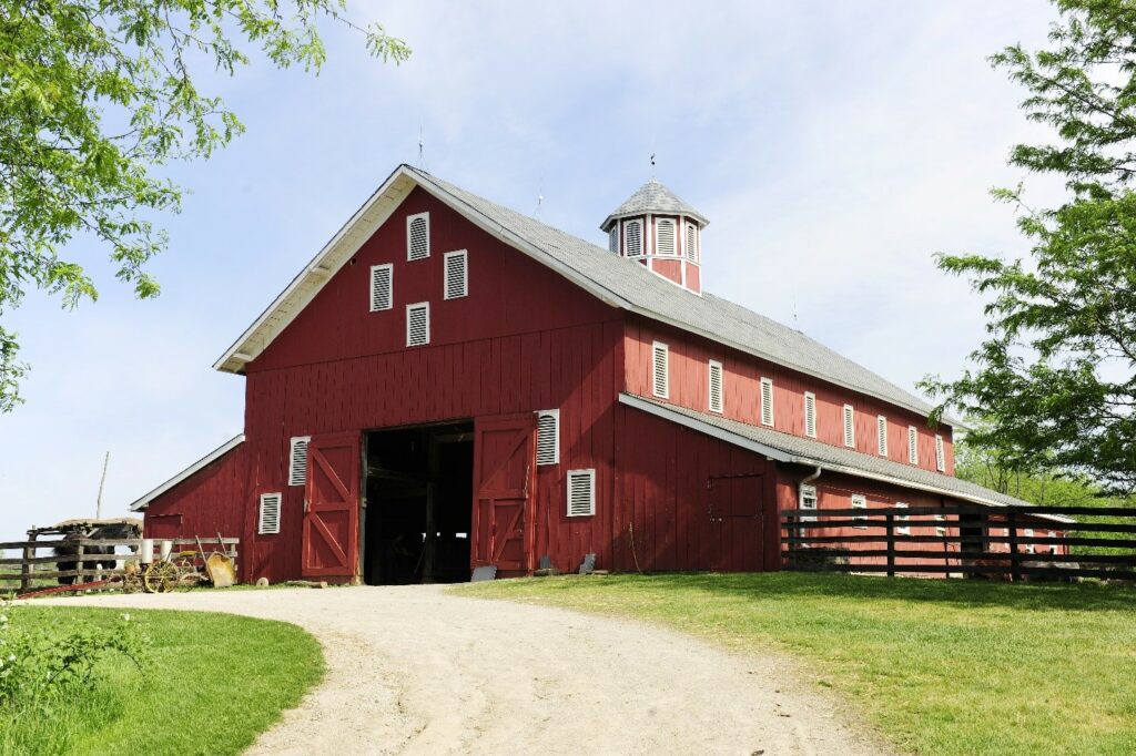 Red barn dirt road through grass