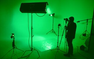 filmmaker in a green set